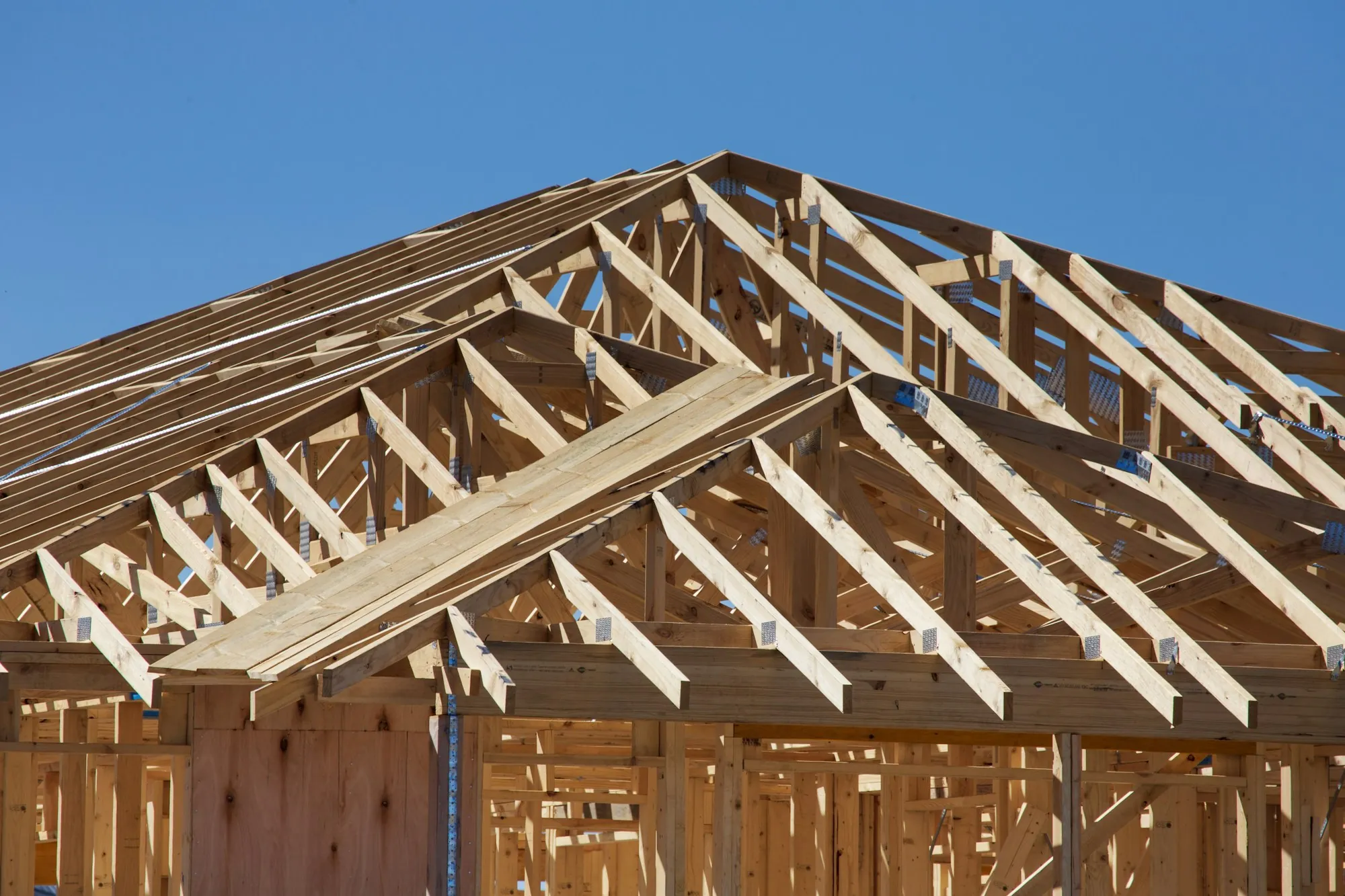 New wood roof trusses set on top of framed walls