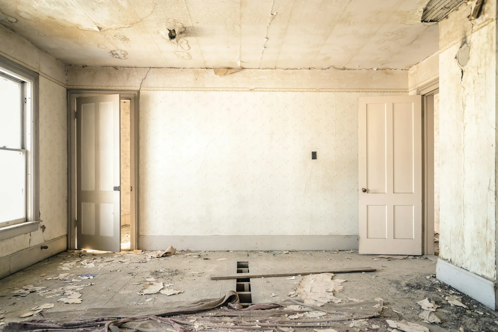 Gutted room with stripped plaster before a remodel