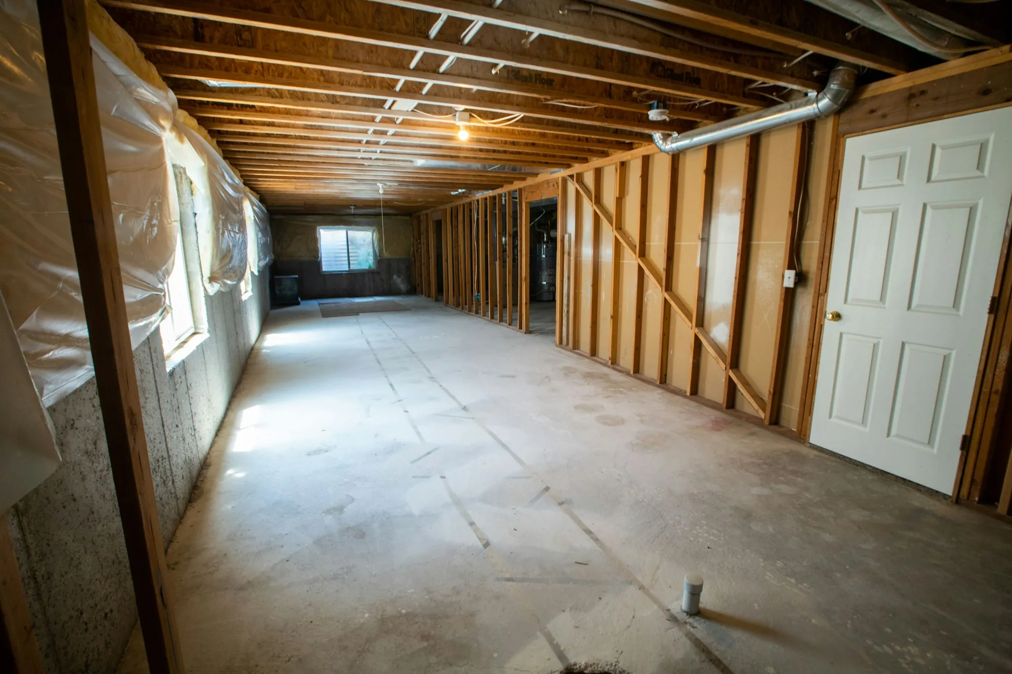 Unfinished basement with open joists ready to be finished